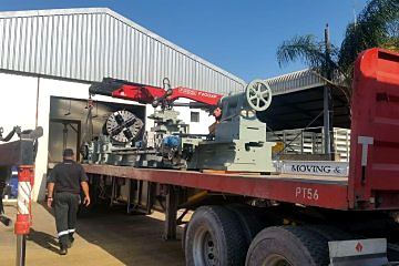 The rebuilt lathe loaded on a flatbed truck for delivery